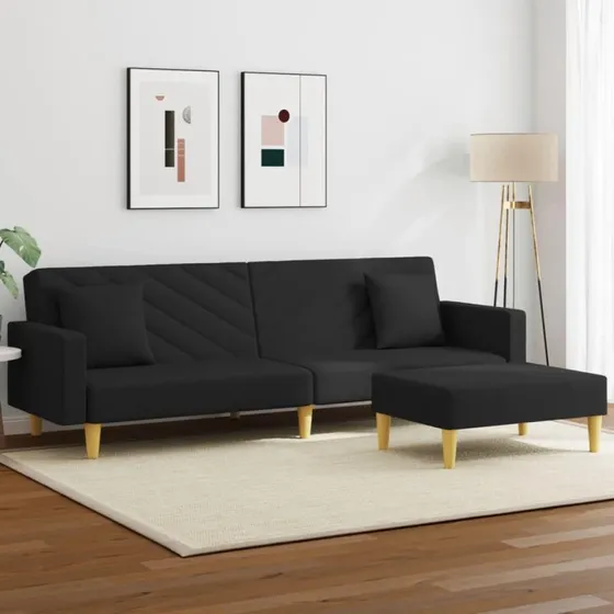 2-personers sovesofa med puder og fodskammel i sort stof